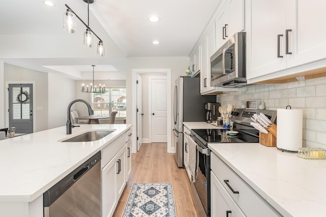 3019 Easy Goer Ln, Greenbrier, TN 37073 - kitchen with appliances with stainless steel finishes, a sink, white cabinetry, decorative backsplash, and recessed lighting