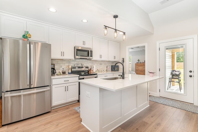 3019 Easy Goer Ln, Greenbrier, TN 37073 - kitchen featuring stainless steel appliances, a sink, tasteful backsplash, white cabinets, and light wood-style flooring