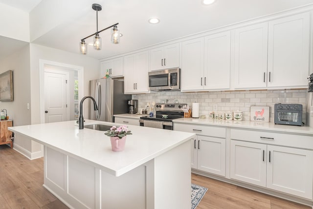 3019 Easy Goer Ln, Greenbrier, TN 37073 - kitchen featuring stainless steel appliances, an island with sink, white cabinets, decorative backsplash, and recessed lighting