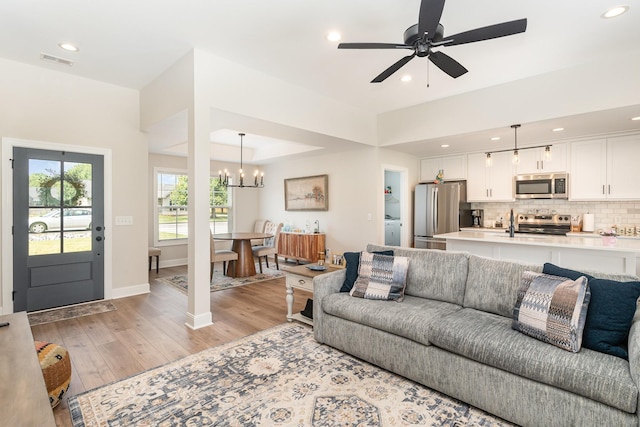 3019 Easy Goer Ln, Greenbrier, TN 37073 - living area with light wood-type flooring, a chandelier, baseboards, recessed lighting, and ceiling fan