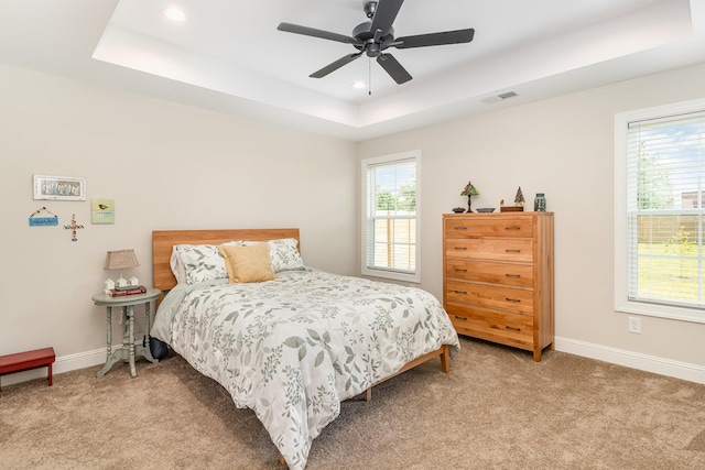 3019 Easy Goer Ln, Greenbrier, TN 37073 - bedroom with multiple windows, light colored carpet, a raised ceiling, and recessed lighting