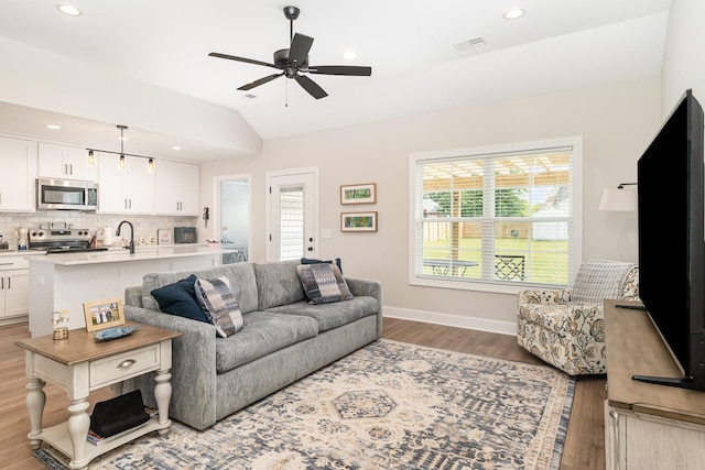3019 Easy Goer Ln, Greenbrier, TN 37073 - living area with light wood-style flooring, vaulted ceiling, healthy amount of natural light, ceiling fan, and baseboards