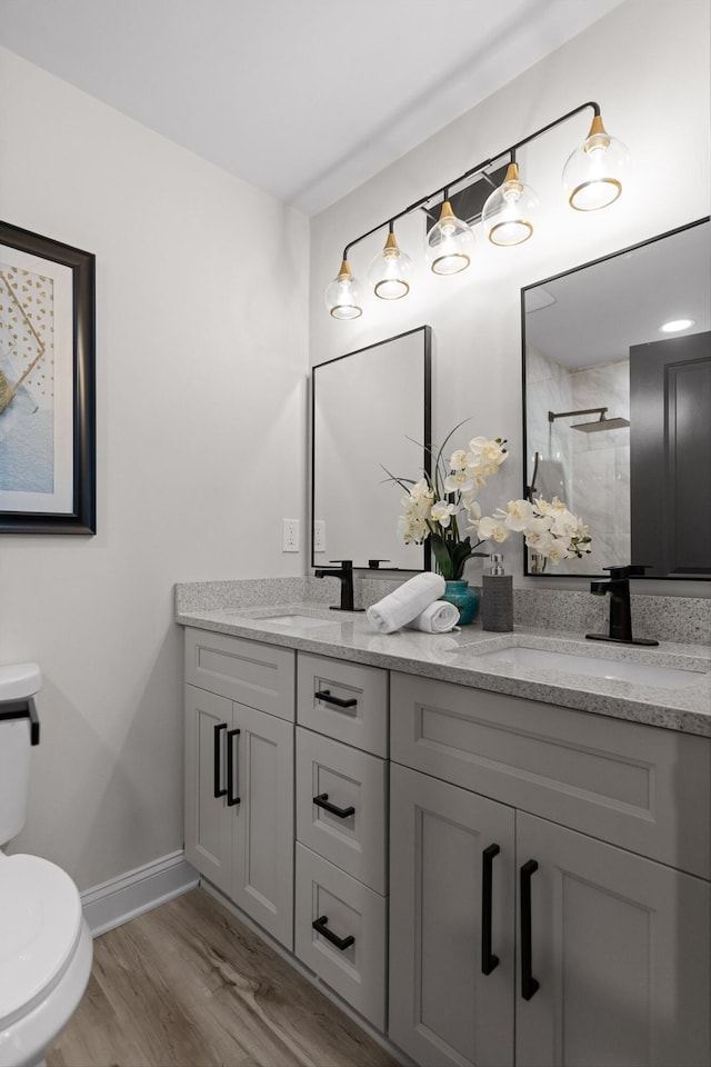 2605 Avalon Hl, Chattanooga, TN 37415 - full bathroom featuring toilet, a stall shower, double vanity, and baseboards