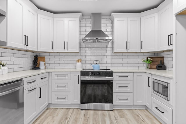 2605 Avalon Hl, Chattanooga, TN 37415 - kitchen with stainless steel appliances, wall chimney exhaust hood, white cabinets, and light stone counters