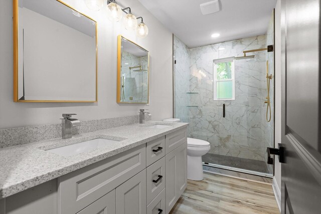 2605 Avalon Hl, Chattanooga, TN 37415 - bathroom featuring double vanity, a marble finish shower, toilet, and wood finished floors