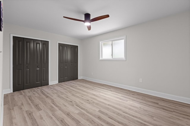 2605 Avalon Hl, Chattanooga, TN 37415 - unfurnished bedroom featuring two closets, light wood-type flooring, baseboards, and ceiling fan
