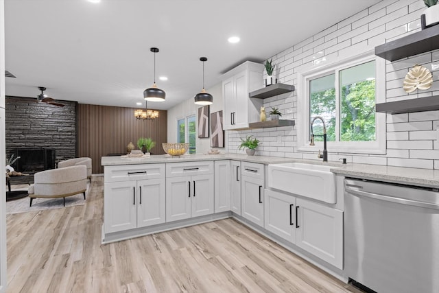 2605 Avalon Hl, Chattanooga, TN 37415 - kitchen featuring open shelves, stainless steel dishwasher, a sink, a peninsula, and a large fireplace