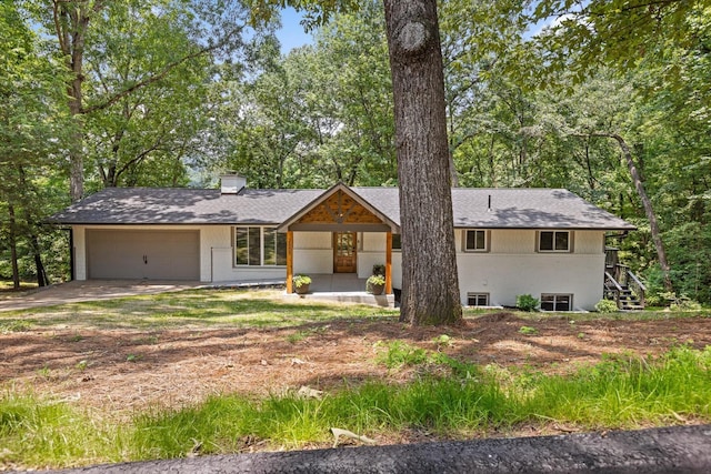 2605 Avalon Hl, Chattanooga, TN 37415 - view of front of house with an attached garage, driveway, a chimney, roof with shingles, and a porch