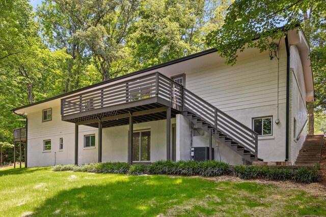 2605 Avalon Hl, Chattanooga, TN 37415 - back of house featuring stairway, a wooden deck, a lawn, and stucco siding