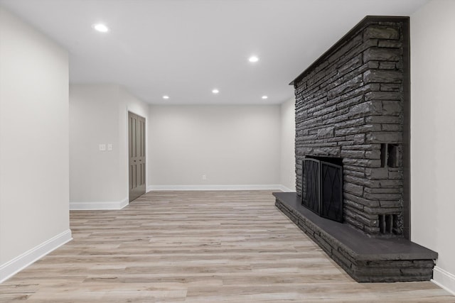 2605 Avalon Hl, Chattanooga, TN 37415 - unfurnished living room with recessed lighting, light wood finished floors, a stone fireplace, and baseboards