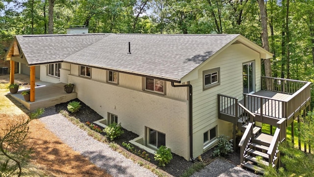 2605 Avalon Hl, Chattanooga, TN 37415 - view of home's exterior with a shingled roof, a deck, a chimney, and view of scattered trees