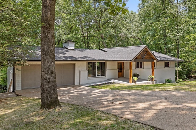 2605 Avalon Hl, Chattanooga, TN 37415 - view of front facade featuring concrete driveway, an attached garage, a chimney, and roof with shingles