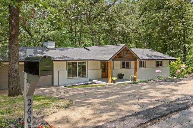 2605 Avalon Hl, Chattanooga, TN 37415 - ranch-style home featuring a shingled roof, a chimney, concrete driveway, and brick siding
