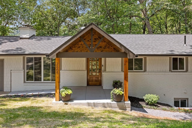 2605 Avalon Hl, Chattanooga, TN 37415 - view of front facade with brick siding, a shingled roof, a chimney, and a patio area