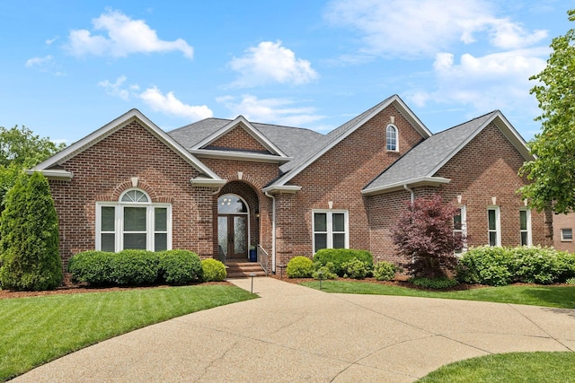 230 Temple Crest Trl, Franklin, TN 37069 - view of front of house featuring brick siding, a front yard, and a shingled roof