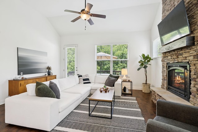 1074 Cantwell Pl, Spring Hill, TN 37174 - living area with dark wood-style flooring, a stone fireplace, a ceiling fan, baseboards, and high vaulted ceiling