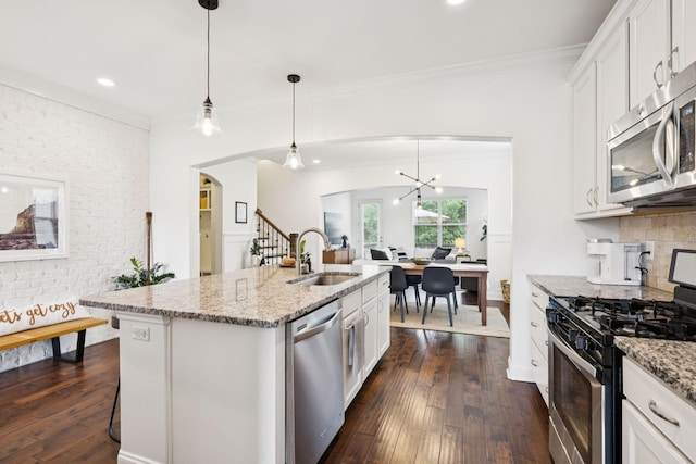 1074 Cantwell Pl, Spring Hill, TN 37174 - kitchen with stainless steel appliances, a sink, dark wood finished floors, arched walkways, and white cabinets