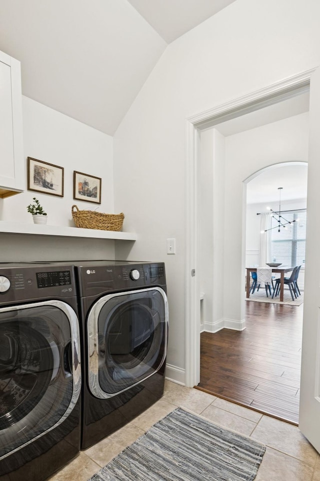 1074 Cantwell Pl, Spring Hill, TN 37174 - laundry room featuring separate washer and dryer, arched walkways, tile patterned floors, and baseboards