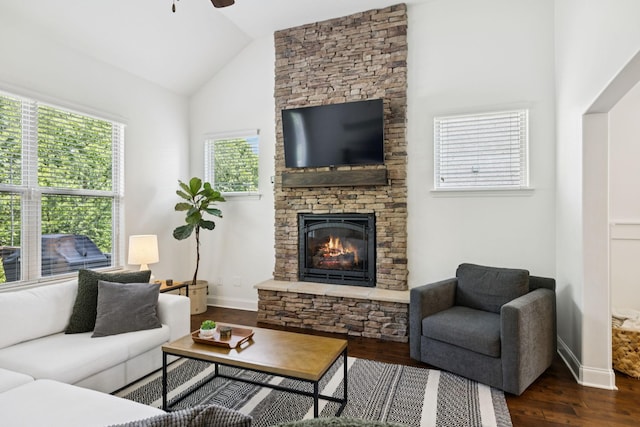1074 Cantwell Pl, Spring Hill, TN 37174 - living room featuring vaulted ceiling, ceiling fan, dark wood-style flooring, a stone fireplace, and baseboards