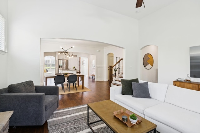 1074 Cantwell Pl, Spring Hill, TN 37174 - living room with arched walkways, dark wood-style floors, ceiling fan, a towering ceiling, and a chandelier