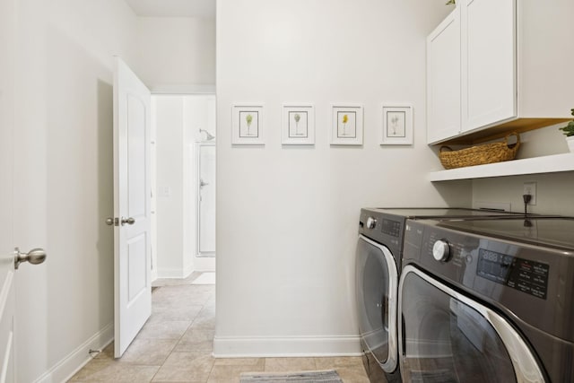 1074 Cantwell Pl, Spring Hill, TN 37174 - laundry area with cabinet space, washing machine and dryer, baseboards, and light tile patterned flooring