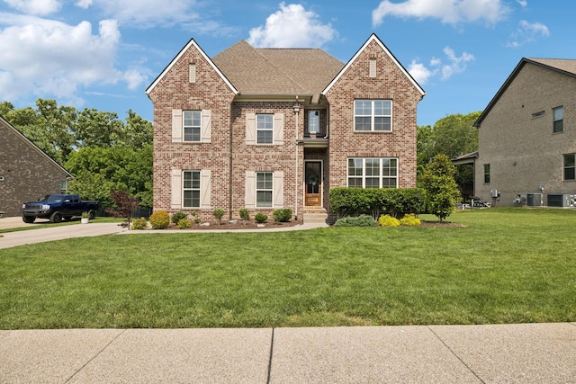 1074 Cantwell Pl, Spring Hill, TN 37174 - view of front of home featuring brick siding, a front lawn, and roof with shingles