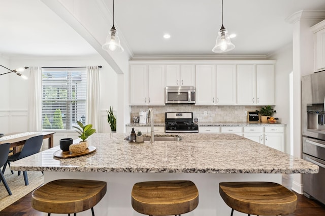 1074 Cantwell Pl, Spring Hill, TN 37174 - kitchen with appliances with stainless steel finishes, white cabinets, tasteful backsplash, ornamental molding, and recessed lighting