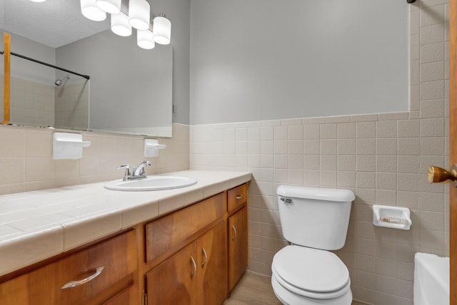 5595 Denmark Rd, Erin, TN 37061 - bathroom featuring toilet, vanity, tile walls, a shower, and a wainscoted wall