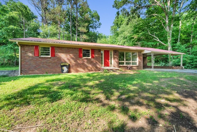 5595 Denmark Rd, Erin, TN 37061 - ranch-style house with brick siding, an attached carport, metal roof, a front yard, and asphalt driveway