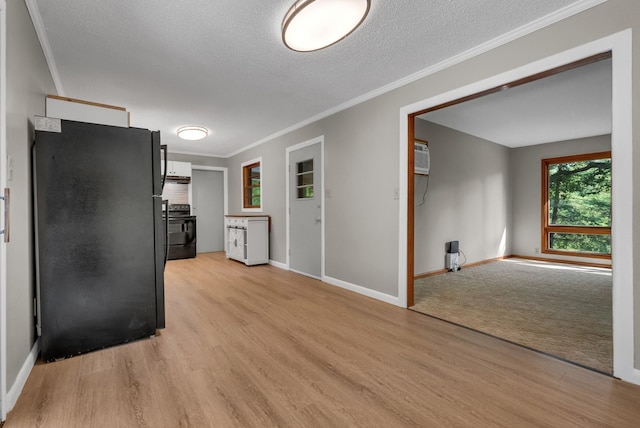 5595 Denmark Rd, Erin, TN 37061 - kitchen featuring freestanding refrigerator, stove, light wood-type flooring, baseboards, and ornamental molding