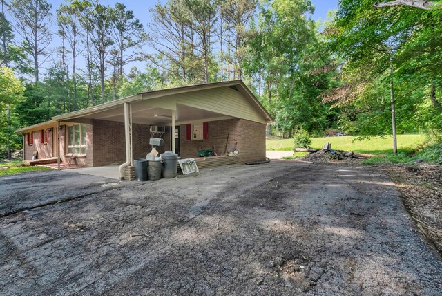 5595 Denmark Rd, Erin, TN 37061 - view of front of property featuring asphalt driveway, brick siding, and an attached carport
