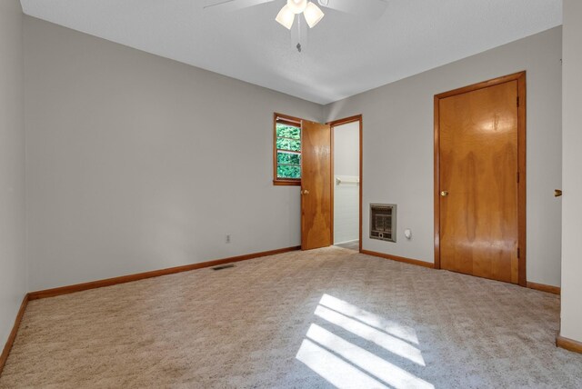 5595 Denmark Rd, Erin, TN 37061 - unfurnished bedroom with carpet flooring, heating unit, baseboards, and a ceiling fan