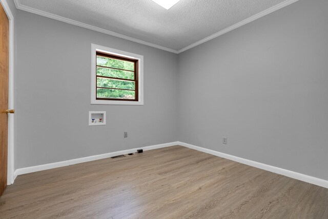 5595 Denmark Rd, Erin, TN 37061 - unfurnished room featuring light wood finished floors, a textured ceiling, crown molding, and baseboards