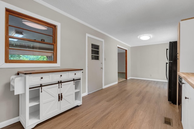5595 Denmark Rd, Erin, TN 37061 - kitchen featuring freestanding refrigerator, open shelves, white cabinetry, light wood-style floors, and ornamental molding