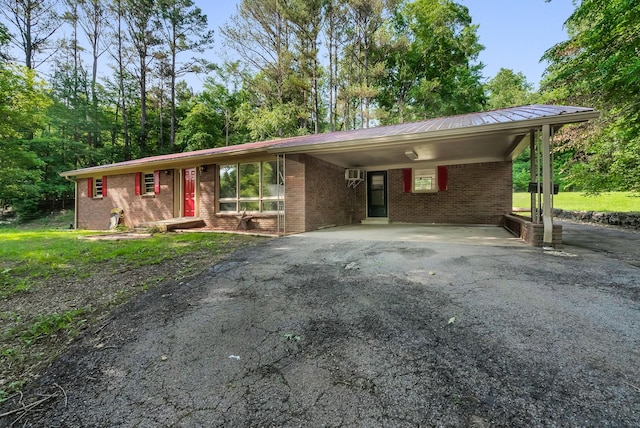 5595 Denmark Rd, Erin, TN 37061 - ranch-style home with driveway, brick siding, metal roof, and an attached carport