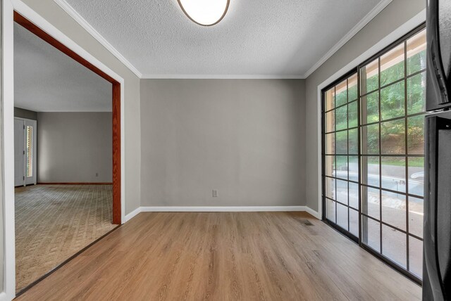 5595 Denmark Rd, Erin, TN 37061 - spare room featuring a textured ceiling, wood finished floors, ornamental molding, and baseboards