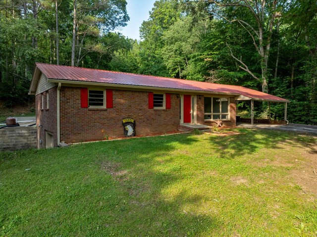 5595 Denmark Rd, Erin, TN 37061 - view of front of house featuring brick siding, asphalt driveway, metal roof, a front lawn, and a view of trees