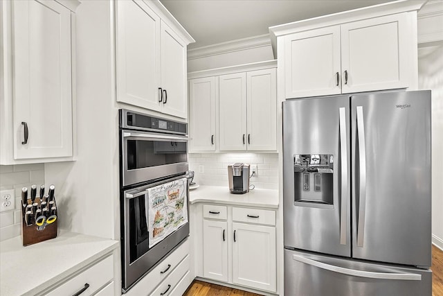 3205 Vinemont Dr, Thompsons Station, TN 37179 - kitchen with stainless steel appliances, light countertops, white cabinets, tasteful backsplash, and crown molding