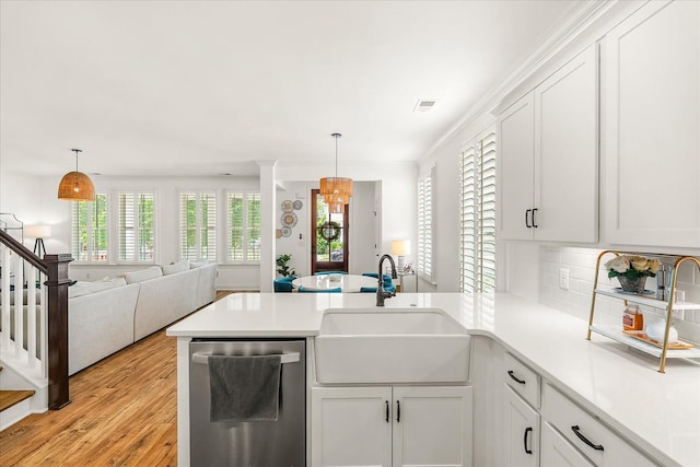 3205 Vinemont Dr, Thompsons Station, TN 37179 - kitchen with stainless steel dishwasher, a sink, a peninsula, and light countertops