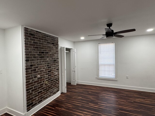 414 Washington St, Columbia, TN 38401 - empty room featuring dark wood-style flooring, baseboards, ceiling fan, recessed lighting, and brick wall