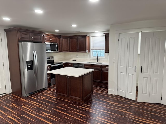 414 Washington St, Columbia, TN 38401 - kitchen with appliances with stainless steel finishes, a sink, dark wood-style flooring, light countertops, and dark brown cabinetry