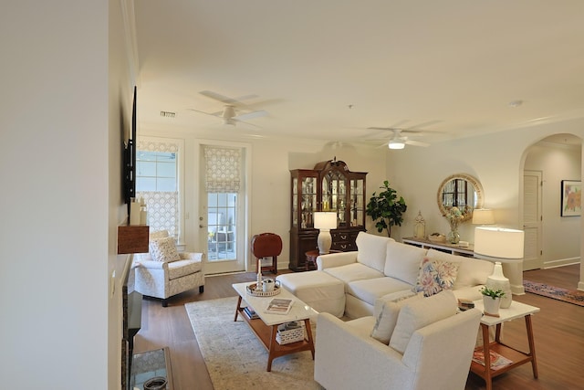 307 Seven Springs Way Unit 304, Brentwood, TN 37027 - living room featuring a ceiling fan, arched walkways, wood finished floors, ornamental molding, and baseboards