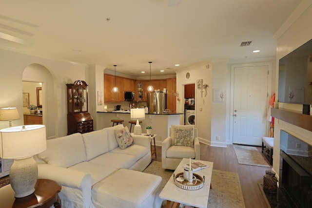 307 Seven Springs Way Unit 304, Brentwood, TN 37027 - living area with washer / dryer, crown molding, recessed lighting, dark wood-type flooring, and arched walkways