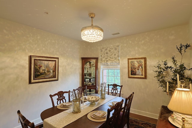 307 Seven Springs Way Unit 304, Brentwood, TN 37027 - dining room with baseboards, a chandelier, and wood finished floors