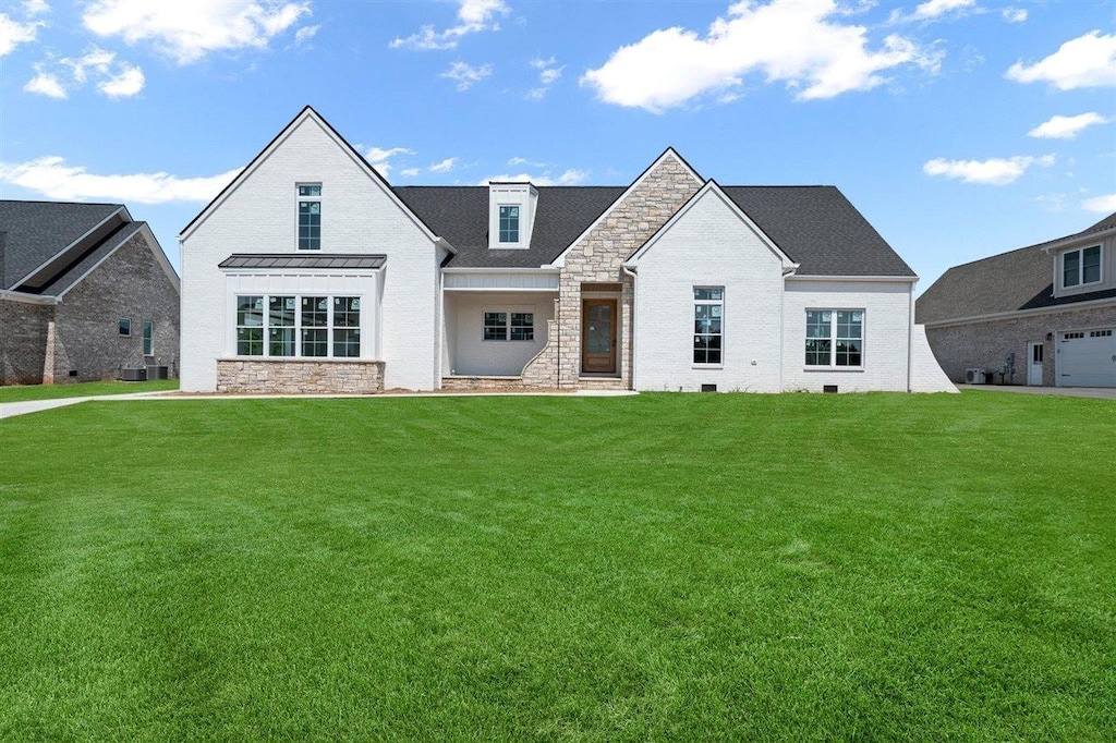 9180 Hermitage Ln, Alvaton, KY 42122 - view of front of home featuring stone siding, a front yard, and central AC