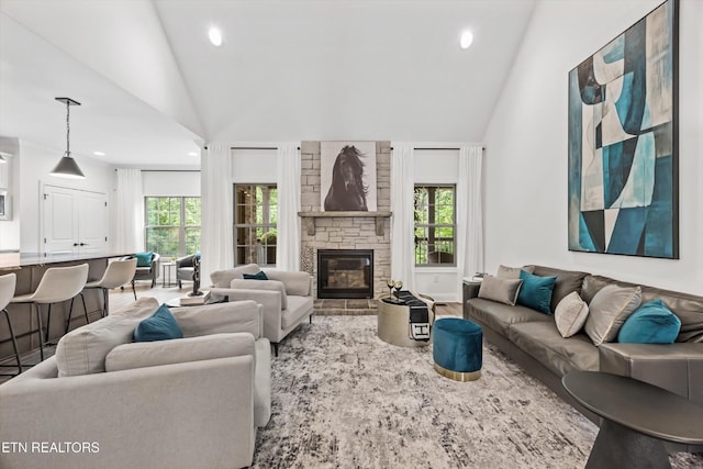 9327 Paradise Valley Ln, Knoxville, TN 37922 - living room featuring plenty of natural light, recessed lighting, a stone fireplace, high vaulted ceiling, and wood finished floors
