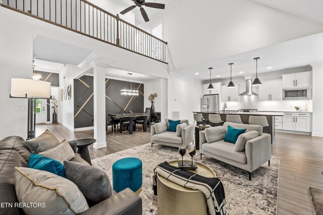 9327 Paradise Valley Ln, Knoxville, TN 37922 - living area with a chandelier, a towering ceiling, light wood-type flooring, a ceiling fan, and recessed lighting