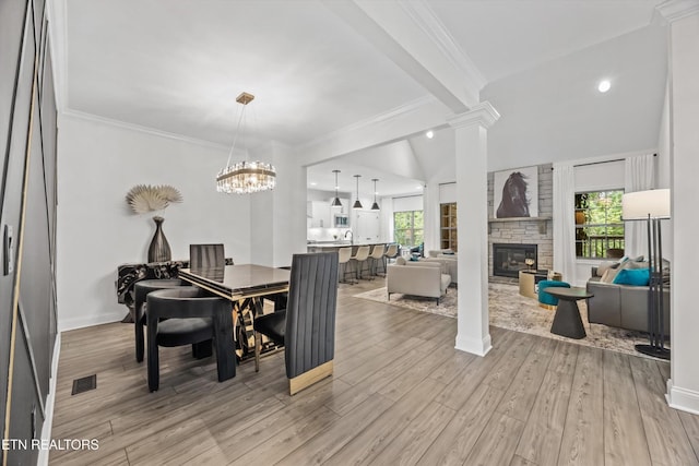 9327 Paradise Valley Ln, Knoxville, TN 37922 - dining area with a fireplace, light wood finished floors, ornate columns, and ornamental molding