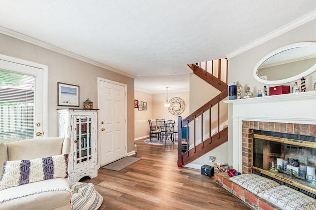 213 Cedarwood Ln, Madison, TN 37115 - living area with stairway, crown molding, wood finished floors, a chandelier, and a fireplace