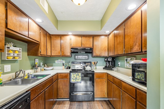 213 Cedarwood Ln, Madison, TN 37115 - kitchen with black appliances, under cabinet range hood, a sink, dark wood-type flooring, and light countertops